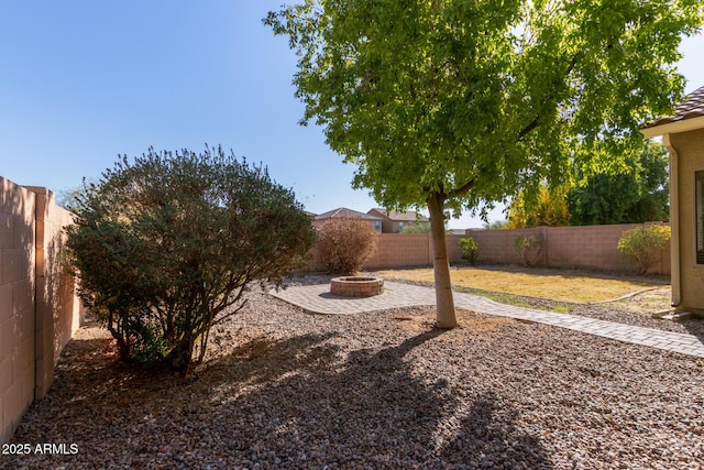 view of yard with an outdoor fire pit