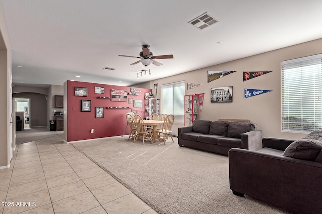 living room with ceiling fan and light carpet