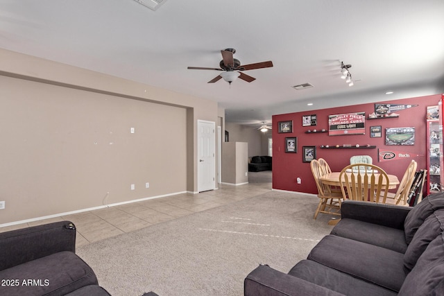 living room with ceiling fan and light tile patterned floors