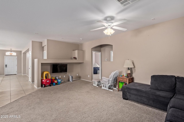 tiled living room with ceiling fan