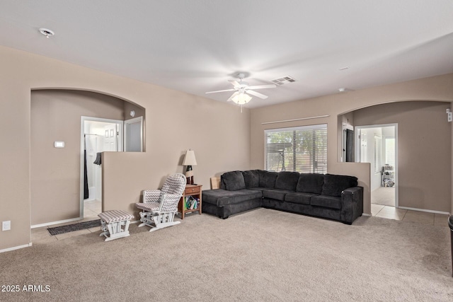 carpeted living room featuring ceiling fan