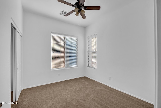 unfurnished room with ceiling fan and light carpet