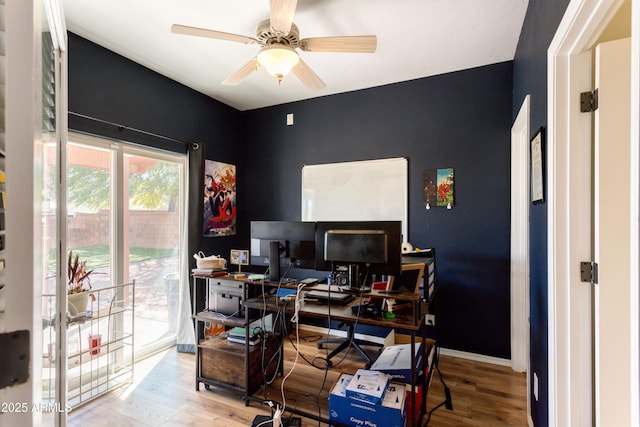 office area with baseboards, a ceiling fan, and wood finished floors