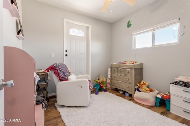 playroom with wood finished floors and a ceiling fan