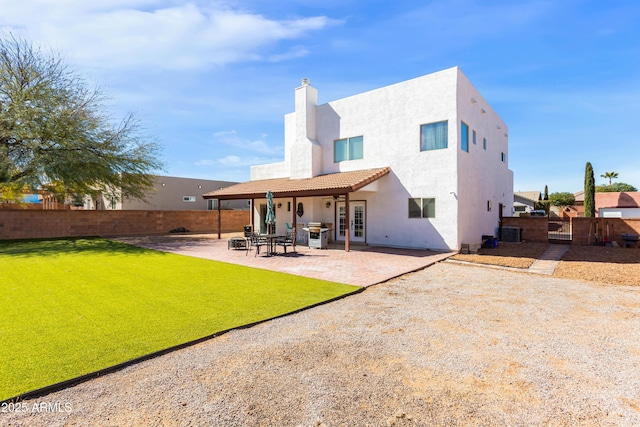 rear view of house featuring a patio area, a fenced backyard, cooling unit, and stucco siding