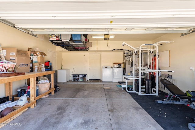 garage with washing machine and dryer and a garage door opener