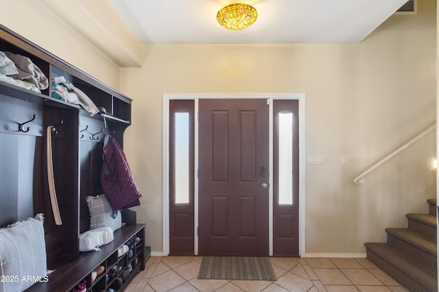 mudroom with light tile patterned floors and baseboards