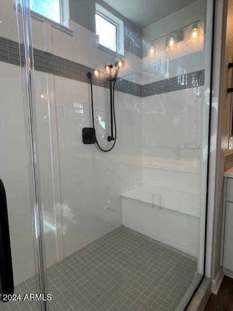 bathroom featuring tile patterned floors, vanity, and walk in shower