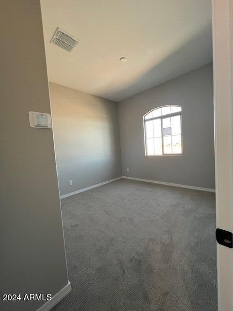 empty room featuring dark colored carpet