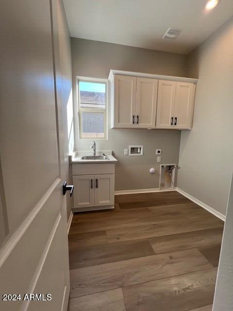 laundry room featuring cabinets, washer hookup, hookup for an electric dryer, gas dryer hookup, and sink