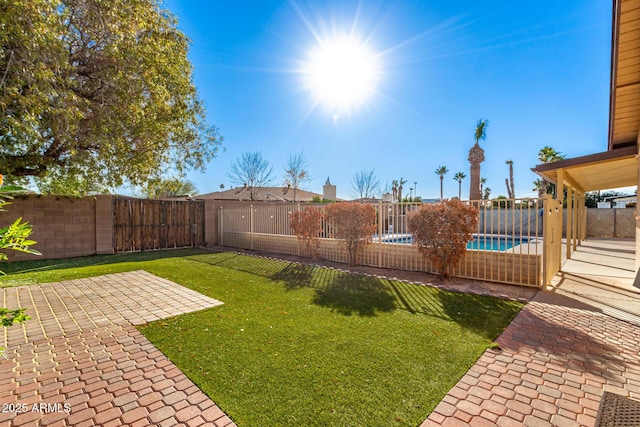 view of yard featuring a patio area and a fenced in pool