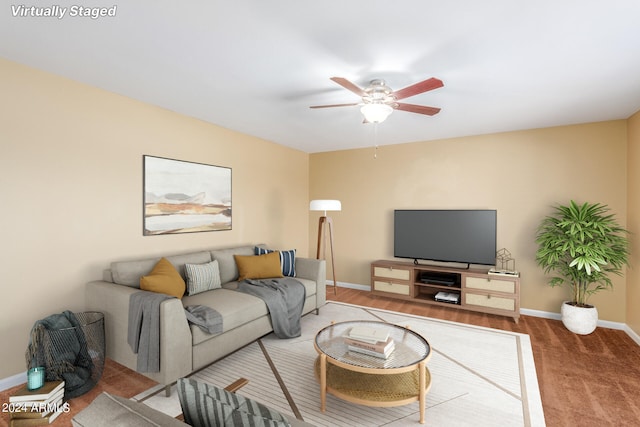 carpeted living room with ceiling fan