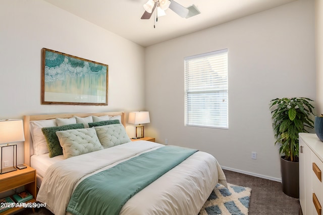 carpeted bedroom featuring a ceiling fan and baseboards