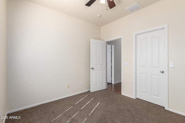 unfurnished bedroom featuring visible vents, baseboards, a ceiling fan, and carpet flooring