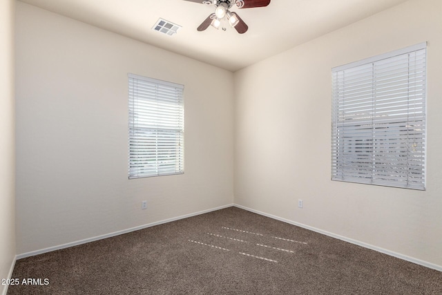 spare room with visible vents, baseboards, carpet, and a ceiling fan