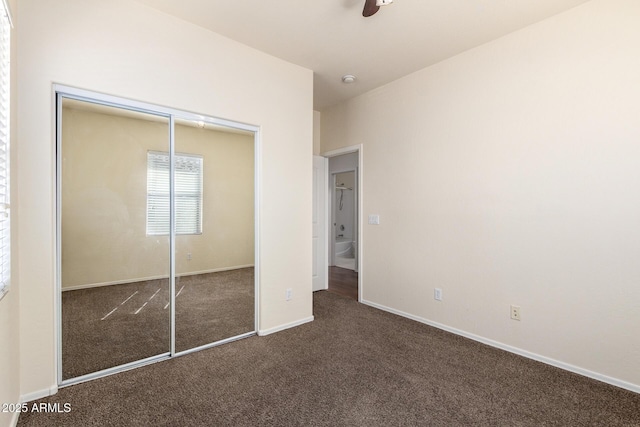 unfurnished bedroom with baseboards, a closet, and carpet floors