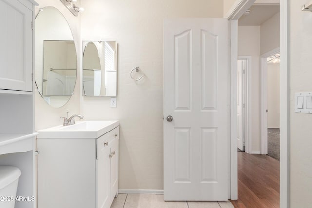 bathroom with vanity, toilet, and baseboards