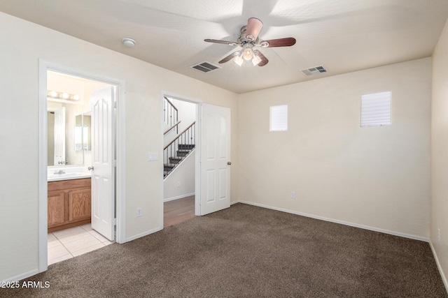 unfurnished bedroom with light carpet, visible vents, and baseboards