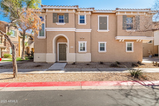 view of property featuring stucco siding and a tiled roof