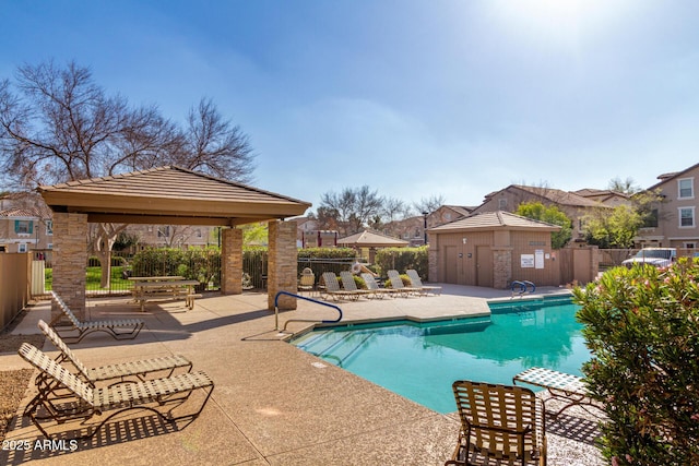 community pool featuring a gazebo, fence, and a patio area