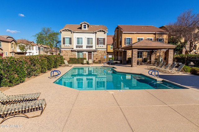 community pool featuring a gazebo, a patio, and fence