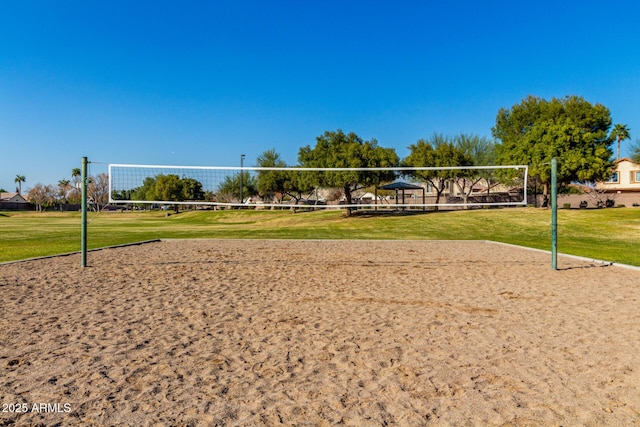 view of property's community with a yard and volleyball court