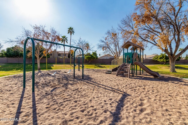 community playground with a yard and fence