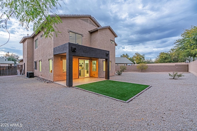 rear view of property featuring central air condition unit and a patio area