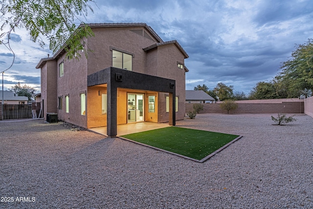 rear view of house featuring central AC and a patio area