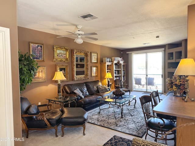 6535 E Superstition Springs Blvd Unit 217, Mesa, AZ 85206 - carpeted living room featuring a ceiling fan and a textured ceiling