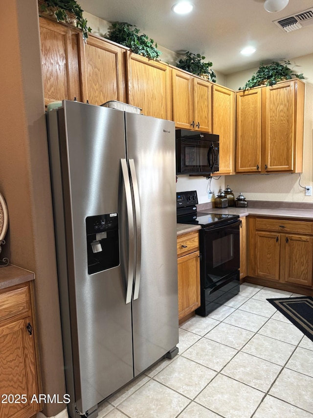 6535 E Superstition Springs Blvd Unit 217, Mesa, AZ 85206 - kitchen featuring black appliances, light tile patterned floors, brown cabinetry, and recessed lighting