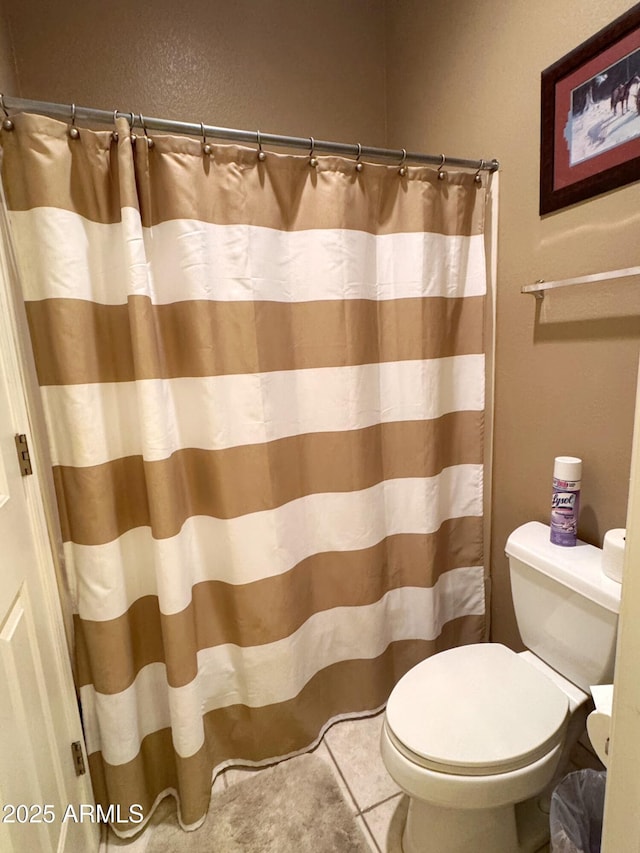 6535 E Superstition Springs Blvd Unit 217, Mesa, AZ 85206 - bathroom featuring toilet, curtained shower, and tile patterned floors