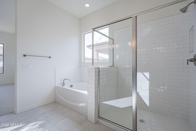 bathroom featuring tile patterned flooring and separate shower and tub