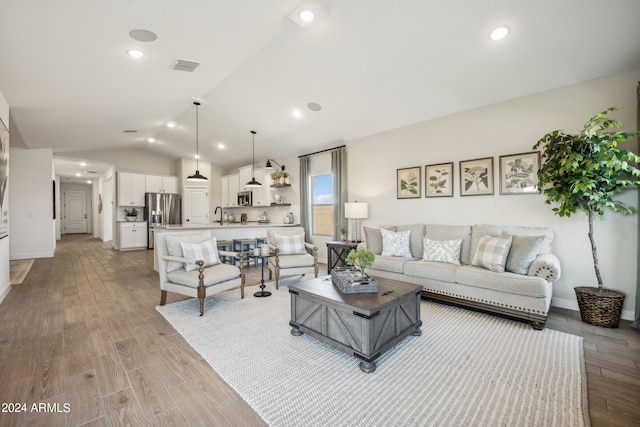 living room with lofted ceiling and light hardwood / wood-style floors