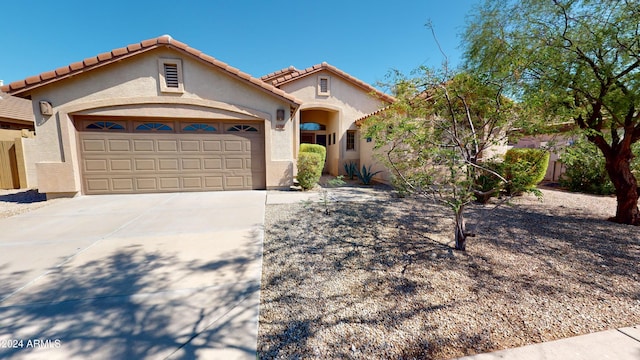 mediterranean / spanish-style house with a garage