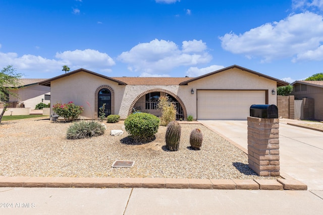 single story home featuring a garage, driveway, and stucco siding