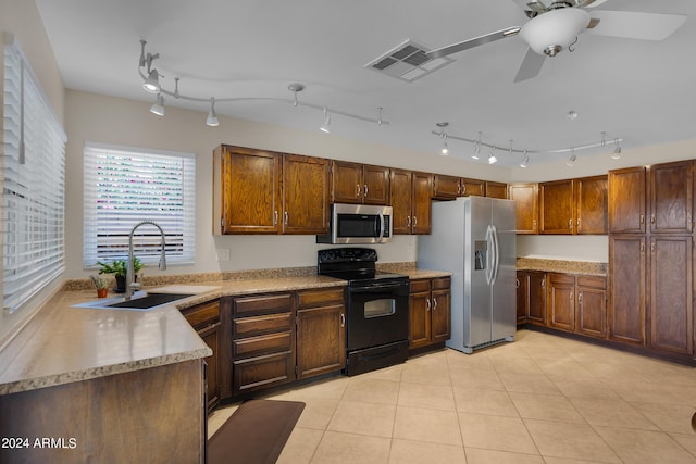 kitchen featuring light tile patterned floors, stainless steel appliances, light countertops, visible vents, and a sink