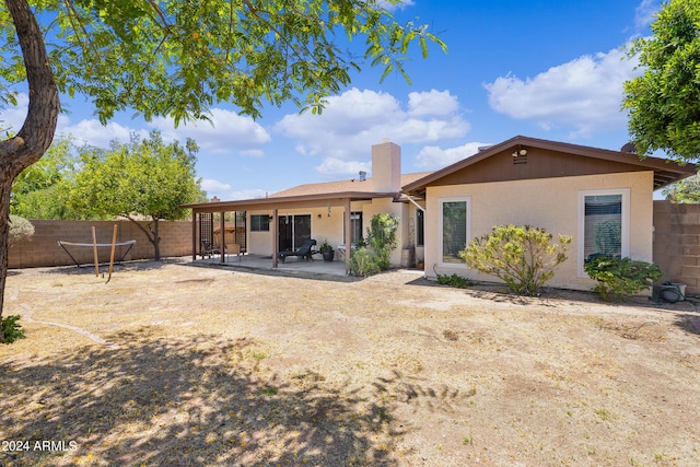 back of property featuring a patio, a fenced backyard, and stucco siding