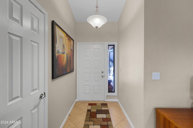 entrance foyer featuring baseboards and light tile patterned flooring