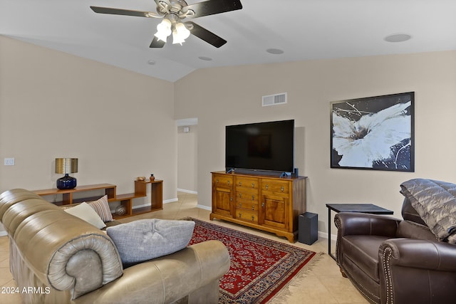 living area with lofted ceiling, light tile patterned floors, a ceiling fan, visible vents, and baseboards