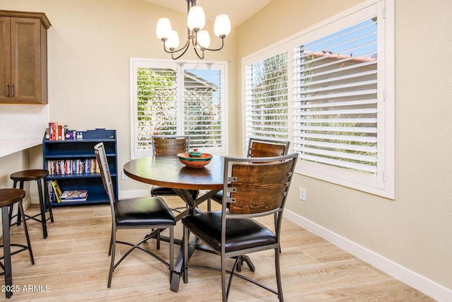 6831 S Coral Gable Dr, Chandler, AZ 85249 - dining area with a chandelier, light wood-type flooring, and baseboards