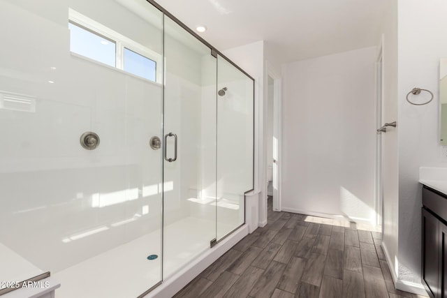 bathroom featuring vanity and a shower with shower door