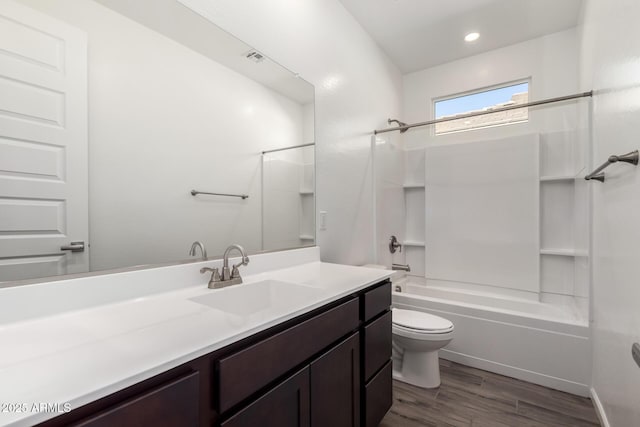 full bathroom featuring shower / bathing tub combination, hardwood / wood-style floors, vanity, and toilet