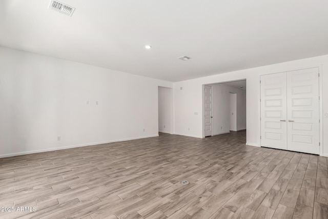 empty room with light hardwood / wood-style flooring