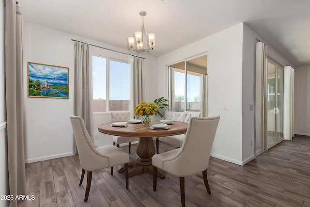 dining room with dark hardwood / wood-style floors and a chandelier