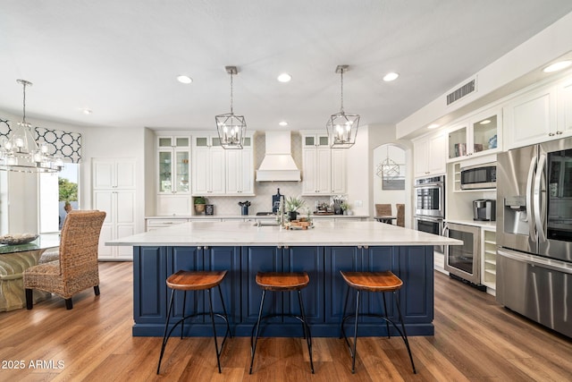 3665 S Jojoba Way, Chandler, AZ 85248 - kitchen featuring appliances with stainless steel finishes, custom exhaust hood, a chandelier, wine cooler, and backsplash