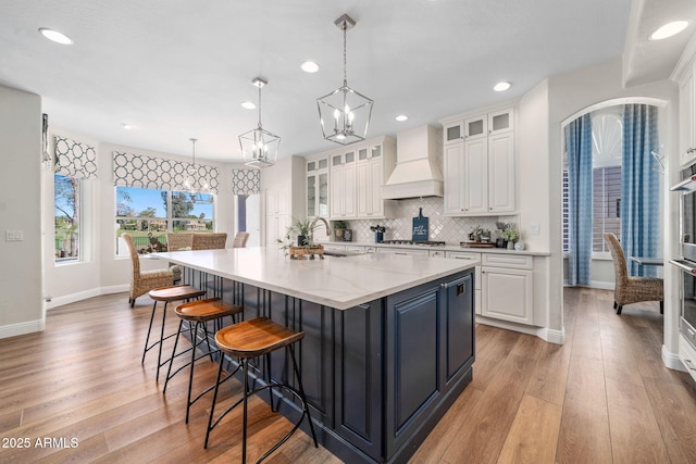 3665 S Jojoba Way, Chandler, AZ 85248 - kitchen featuring custom range hood, stainless steel gas cooktop, white cabinetry, baseboards, and recessed lighting