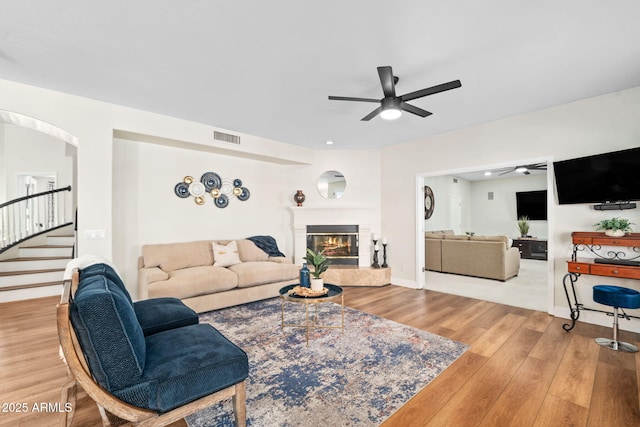 3665 S Jojoba Way, Chandler, AZ 85248 - living area with a ceiling fan, wood finished floors, stairway, a fireplace, and baseboards