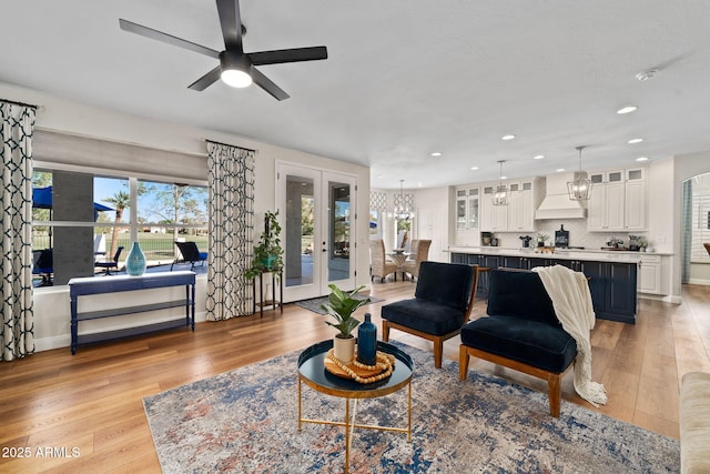 3665 S Jojoba Way, Chandler, AZ 85248 - living room featuring ceiling fan, light wood-style flooring, recessed lighting, a chandelier, and french doors