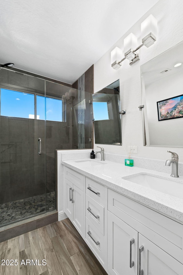 3665 S Jojoba Way, Chandler, AZ 85248 - bathroom featuring a stall shower, double vanity, and wood finished floors